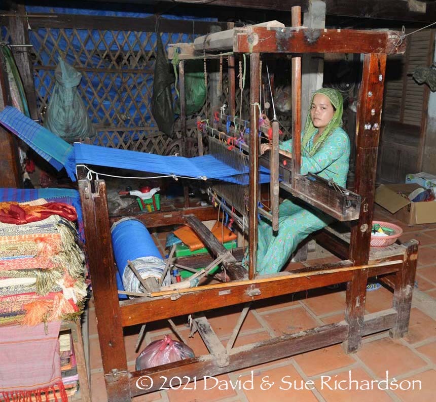 Description: A Cham weaver at her frame loom