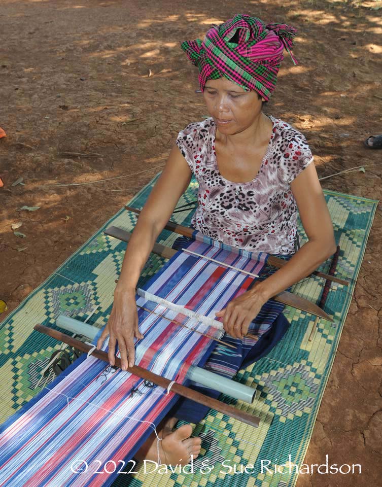 Description: A woman weaver wearing a cotton krama