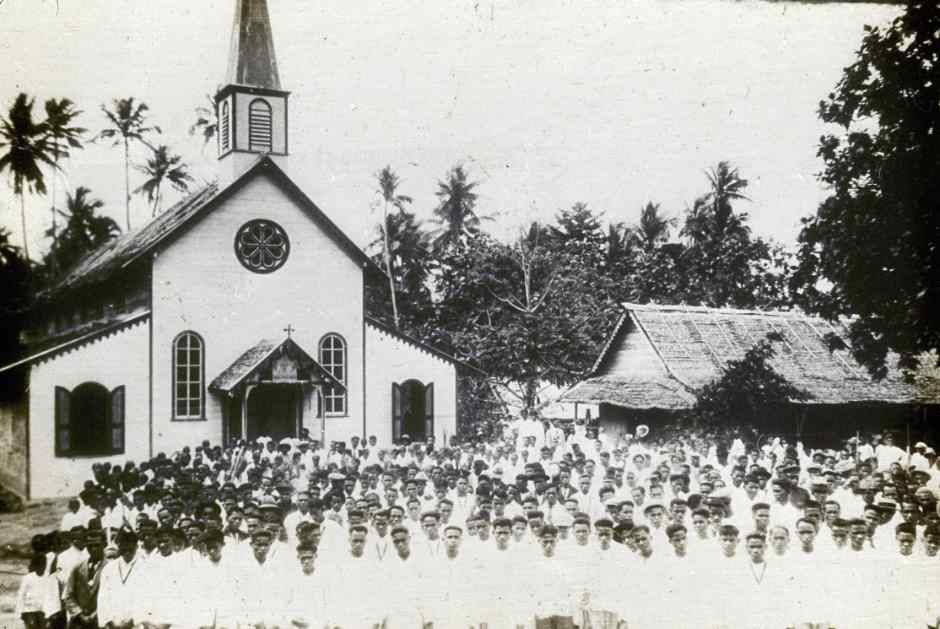 Description: Worshippers outside a Roman Catholic church