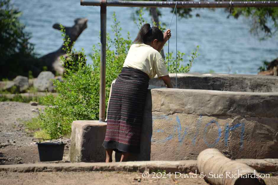 Description: A woman fetching water from the well in Lewo Tobi
