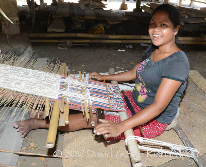 Description: Weaving under the house at Uma Bara